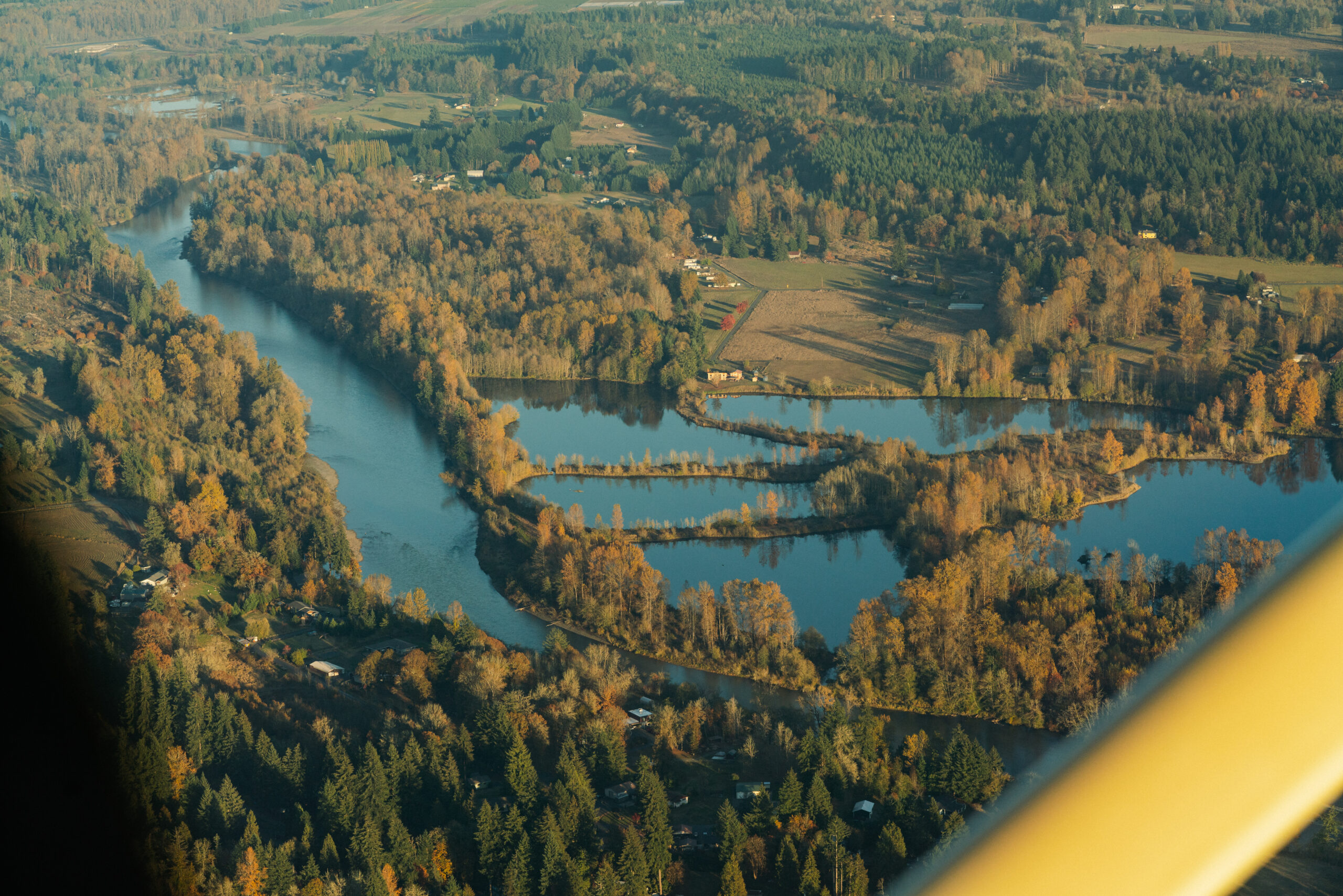 Aerial view of rivers, forests, and farmland highlighting a connected landscape for wildlife conservation.